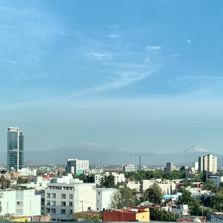 Skyline photo of Mexico City with volcano in the background